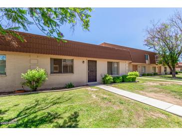 Traditional townhome featuring desert landscaping, a private entry, and a light-colored walkway at 1634 E Donner Dr, Tempe, AZ 85282