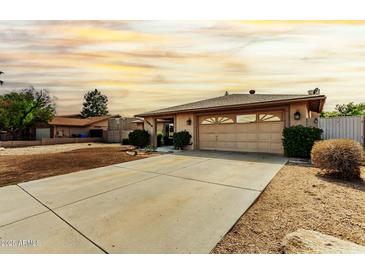Charming single-story home showcasing a well-maintained front yard and two car garage at 18814 N 33Rd Ave, Phoenix, AZ 85027