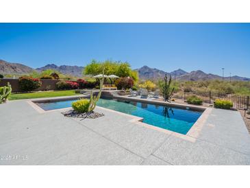 Stunning pool area with mountain views, comfortable seating, and lush desert landscaping at 19829 N 97Th St, Scottsdale, AZ 85255