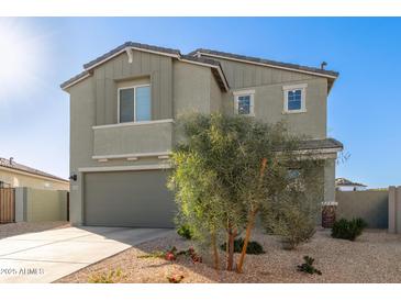Charming two-story home boasts a neutral color palette, desert landscaping, and a welcoming two-car garage at 22962 N 182Nd Ln, Surprise, AZ 85387