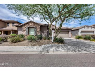Charming single-Gathering home featuring stone accents, desert landscaping, and a welcoming two-car garage at 29214 N 19Th Ln, Phoenix, AZ 85085