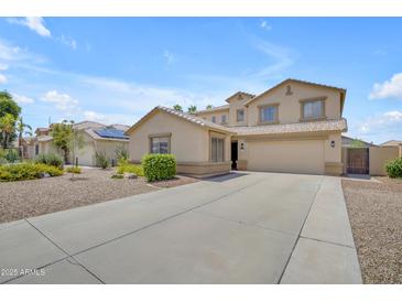 Inviting beige two-story home with a spacious driveway and desert landscaping at 3349 E Flamingo Ct, Gilbert, AZ 85297
