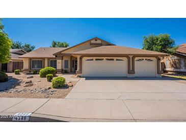 Charming single-story home featuring a three-car garage, landscaped yard and neutral color palette at 4349 W Cielo Grande --, Glendale, AZ 85310