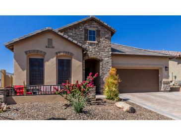 Charming single-story home with stone accents, desert landscaping, and a welcoming front porch at 6912 E Quill St, Mesa, AZ 85207
