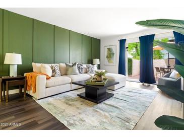 Stylish living room featuring a comfortable sectional sofa and access to a private outdoor patio at 7350 N Via Paseo Del Sur -- # P105, Scottsdale, AZ 85258