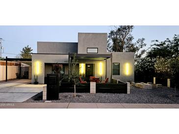 Modern home featuring stylish lighting, a covered patio, and a zero landscape front yard at 1211 E Hayward Ave, Phoenix, AZ 85020