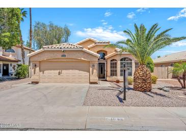 Charming single-story home with stucco facade, tile roof, desert landscaping, and attached two-car garage at 1882 W Wildhorse Dr, Chandler, AZ 85286