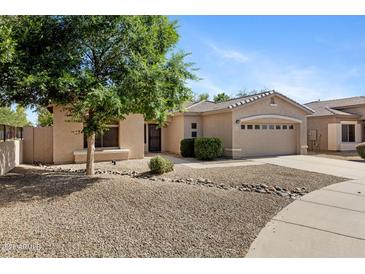 Charming single-story home showcasing desert landscaping, a spacious driveway, and a two-car garage at 21299 E Roundup Way, Queen Creek, AZ 85142