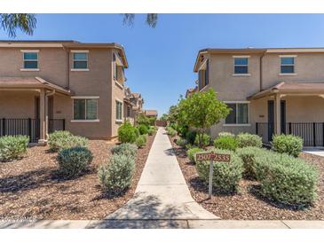 Attractive townhome exteriors feature well-maintained landscaping and neutral color palette at 2519 N 73Rd Dr, Phoenix, AZ 85035