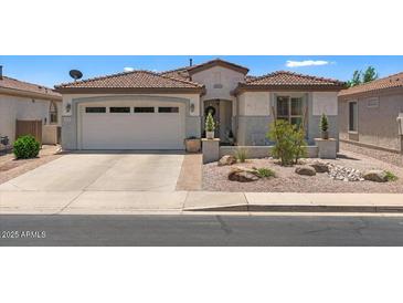 Charming single-story home with a well-maintained yard and a two-car garage at 4649 E Sourwood Dr, Gilbert, AZ 85298