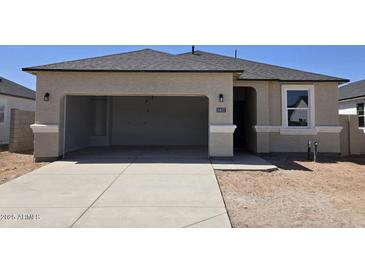 Charming single-story home featuring a two-car garage, a well-maintained stucco exterior, and a neatly paved driveway at 5457 E Mearn Rd, San Tan Valley, AZ 85140