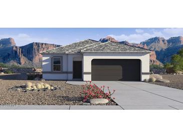 Charming single-story home features neutral stucco, grey roof, two-car garage and desert landscaping at 5457 E Mearn Rd, San Tan Valley, AZ 85140
