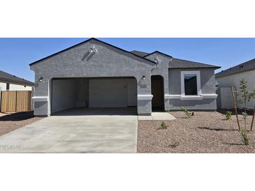 Charming single-story home with a spacious two-car garage and low-maintenance front yard at 5575 E Mearn Rd, San Tan Valley, AZ 85140