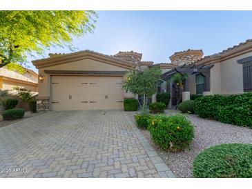 Inviting home exterior features a two-car garage and manicured landscaping for great curb appeal at 6202 E Mckellips Rd # 25, Mesa, AZ 85215
