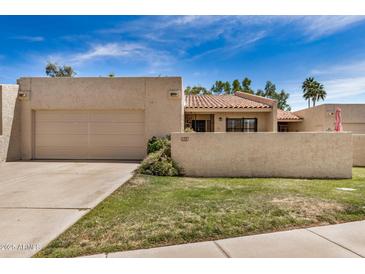 Charming home with stucco exterior, tile roof, and two-car garage, blending style and practicality at 7921 E Bonita Dr, Scottsdale, AZ 85250