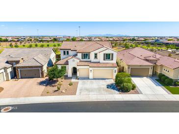 Aerial view of a two-story home with three-car garage, tile roof, and mountain views at 9677 W Patrick Ln, Peoria, AZ 85383