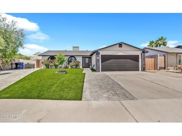 Charming single-story home featuring well-kept landscaping and a two-car garage at 1914 W Onza Ave, Mesa, AZ 85202