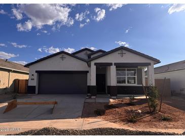 Charming single-story home featuring a gray color scheme, a two-car garage, and drought-resistant landscaping at 22610 N Lynn St, Maricopa, AZ 85138