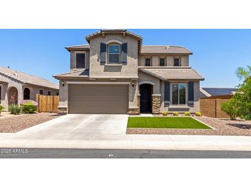 Charming two-story home boasts a well-manicured lawn, complemented by a two-car garage and inviting curb appeal at 24733 N 96Th Ln, Peoria, AZ 85383