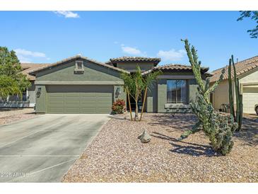 Charming single-story home featuring desert landscaping and a spacious two-car garage at 30031 N Little Leaf Dr, San Tan Valley, AZ 85143