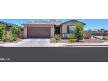 Charming single-story home featuring a two-car garage and desert landscaping at 35175 W Marin Ave, Maricopa, AZ 85138
