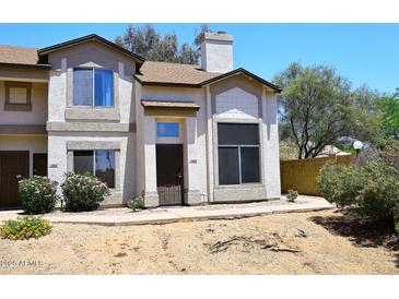 Charming two-story home with desert landscaping, a chimney, and a secure front door at 4114 E Union Hills Dr # 1088, Phoenix, AZ 85050