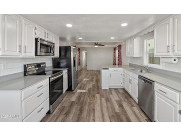 Spacious kitchen with stainless steel appliances, ample counter space and wood-look vinyl floors at 535 S Alma School Rd # 17, Mesa, AZ 85210