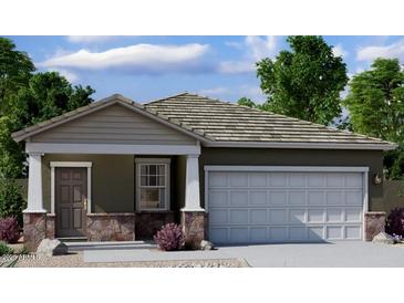 Charming single-story home with stone accents and a two-car garage, offering a cozy and inviting curb appeal at 5781 E Iris Dr, Florence, AZ 85132