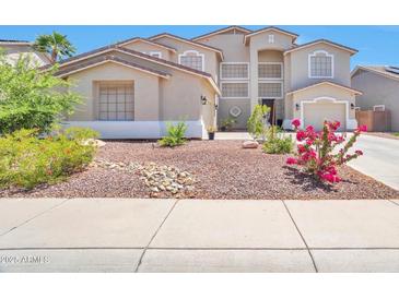 Charming two-story home with a landscaped yard and a neutral color palette at 6027 N 132Nd Dr, Litchfield Park, AZ 85340