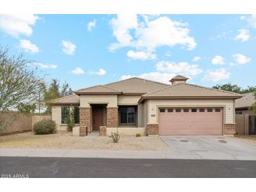 Inviting single-story home with desert landscaping and a two-car garage at 6103 S 54Th Ave, Laveen, AZ 85339
