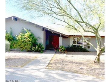 Charming single-story home with a well-maintained landscaped front yard and welcoming entrance at 6408 E Gary Rd, Scottsdale, AZ 85254
