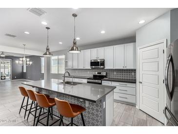 Modern kitchen features sleek countertops, stainless steel appliances, and a stylish backsplash at 7824 S 33Rd Ln, Laveen, AZ 85339
