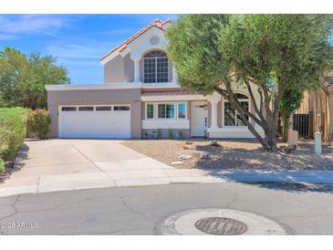 Inviting two-story home featuring a well-manicured front yard and a spacious two-car garage at 1130 S Surfside Dr, Gilbert, AZ 85233