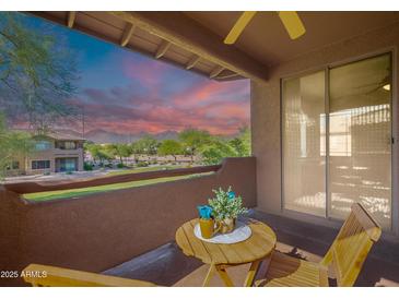Private balcony features peaceful desert views, cozy seating, and a beautiful sunset at 11500 E Cochise Dr # 2088, Scottsdale, AZ 85259