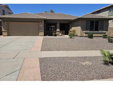 Inviting single-story home with a low-maintenance desert landscape and covered entry at 15352 W Ventura St, Surprise, AZ 85379