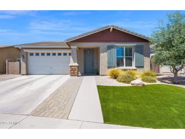 Beautiful single-story home with well-maintained lawn, desert landscaping, and a two car garage at 22262 E Cherrywood Ct, Queen Creek, AZ 85142