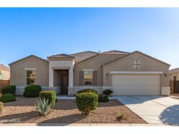 Beautiful single-story home featuring a two-car garage and well-manicured desert landscaping at 30089 W Rockmount Ave, Buckeye, AZ 85396