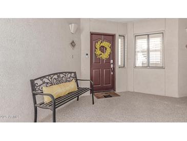 Inviting front door with a cheerful wreath and bench, creating a warm and welcoming entrance at 5104 N 32Nd St # 144, Phoenix, AZ 85018
