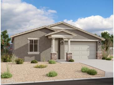 Charming single-story home featuring neutral stucco, a two-car garage, and a covered entryway at 5516 W Piedmont Rd, Laveen, AZ 85339