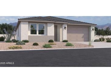 Charming single-story home with a neutral color scheme, well-maintained landscaping, and an attached two-car garage at 9532 W Parkway Dr, Tolleson, AZ 85353