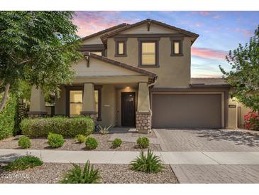 Charming two-story home featuring a well-manicured lawn and a neutral color palette at 10221 E Wavelength Ave, Mesa, AZ 85212