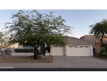 Charming single-story home with a well-maintained front yard and three-car garage at 12955 E Sahuaro Dr, Scottsdale, AZ 85259