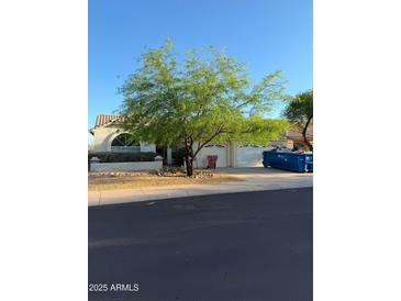 Charming single-story home with a two-car garage and mature desert landscaping at 12955 E Sahuaro Dr, Scottsdale, AZ 85259