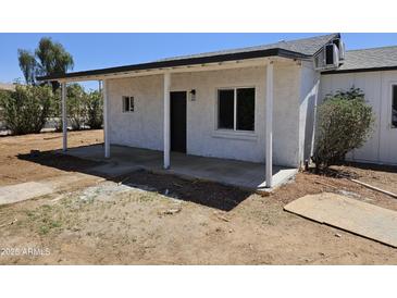 Charming home exterior with a covered porch, enhancing curb appeal and offering a welcoming entrance at 15445 N Verde St, Surprise, AZ 85378