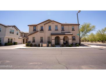 Charming two-story townhome with neutral stucco exterior and well-maintained landscaping at 16425 W Latham St, Goodyear, AZ 85338