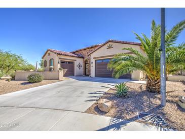 Charming single-story home featuring a three-car garage and desert landscaping at 189 N Rainbow Way, Casa Grande, AZ 85194