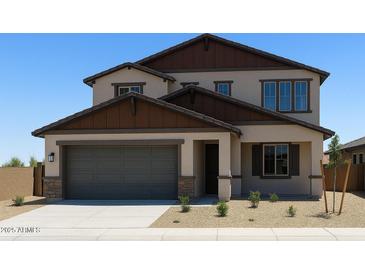 Charming two-story home featuring a gray two-car garage, complemented by a well-maintained, xeriscaped front yard at 20645 N 226Th Ln, Surprise, AZ 85387