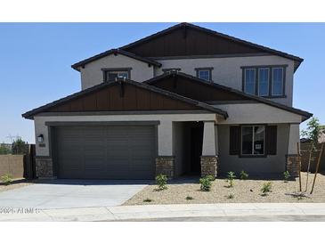 Charming two-story home with a two-car garage and neatly manicured landscaping at 20645 N 226Th Ln, Surprise, AZ 85387