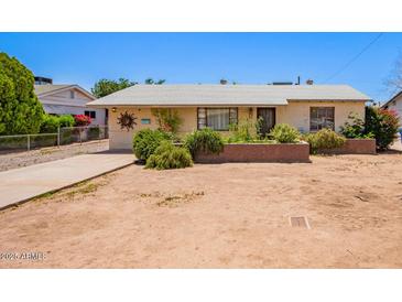 Charming single-story home with desert landscaping, a quaint front yard, and a welcoming entrance at 3247 E Sheridan St, Phoenix, AZ 85008