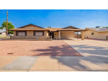 Charming single-story brick home featuring a carport and low-maintenance desert landscaping at 3901 W Augusta Ave, Phoenix, AZ 85051